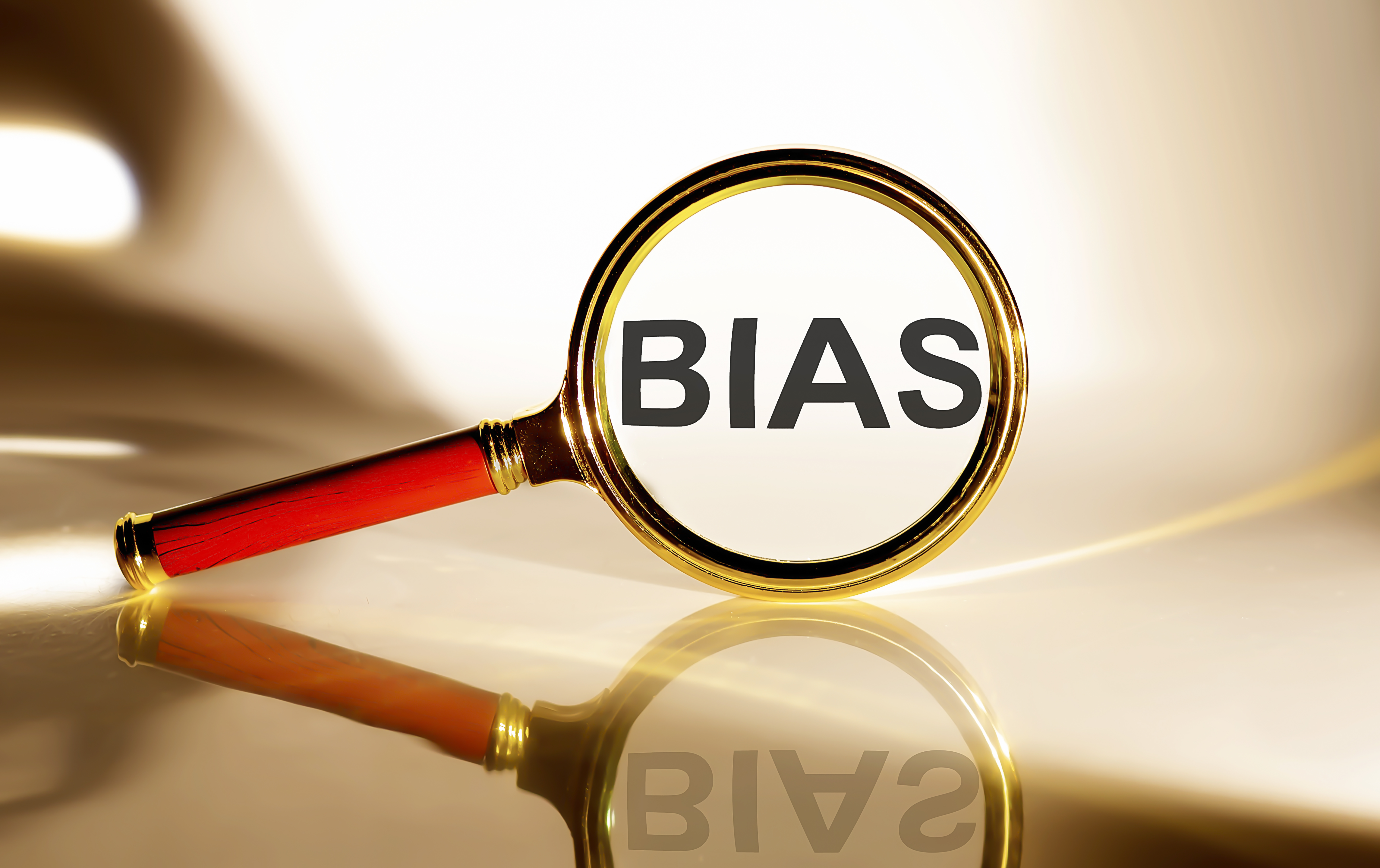 BIAS concept. Magnifier glass with text on the white background in sunlight.