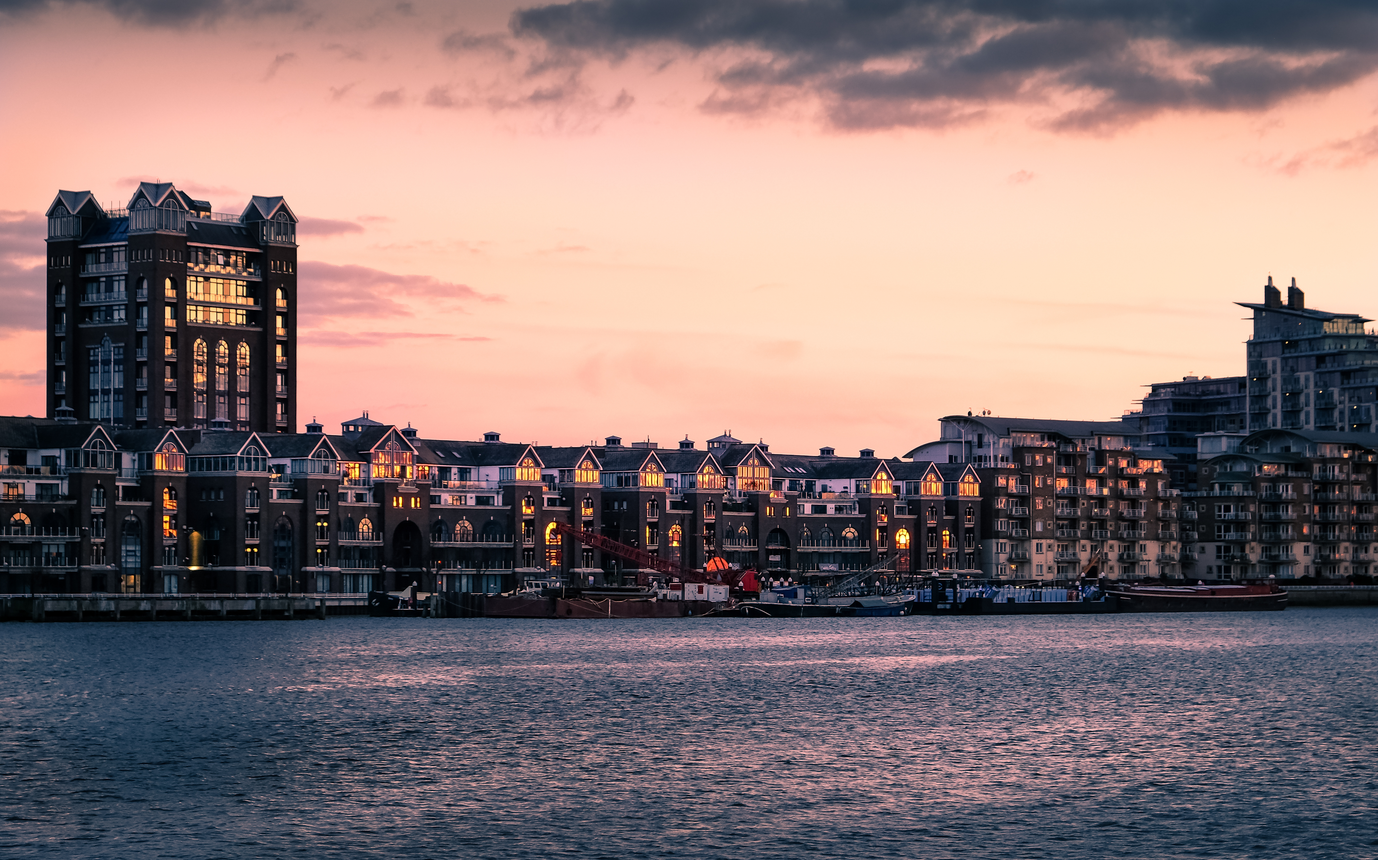 London, England - February 19, 2016 - River Thames at sunset at Battersea Riverside, with apartment buildings of Fulham.