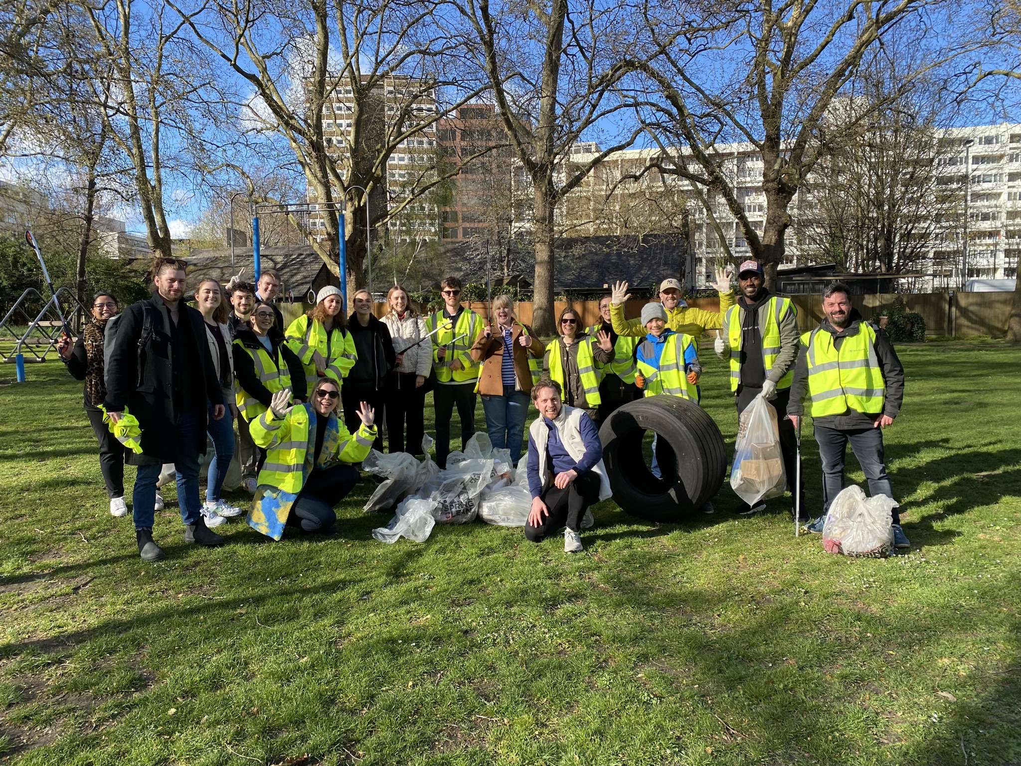 Large group of people litter picking, in a local London park. 