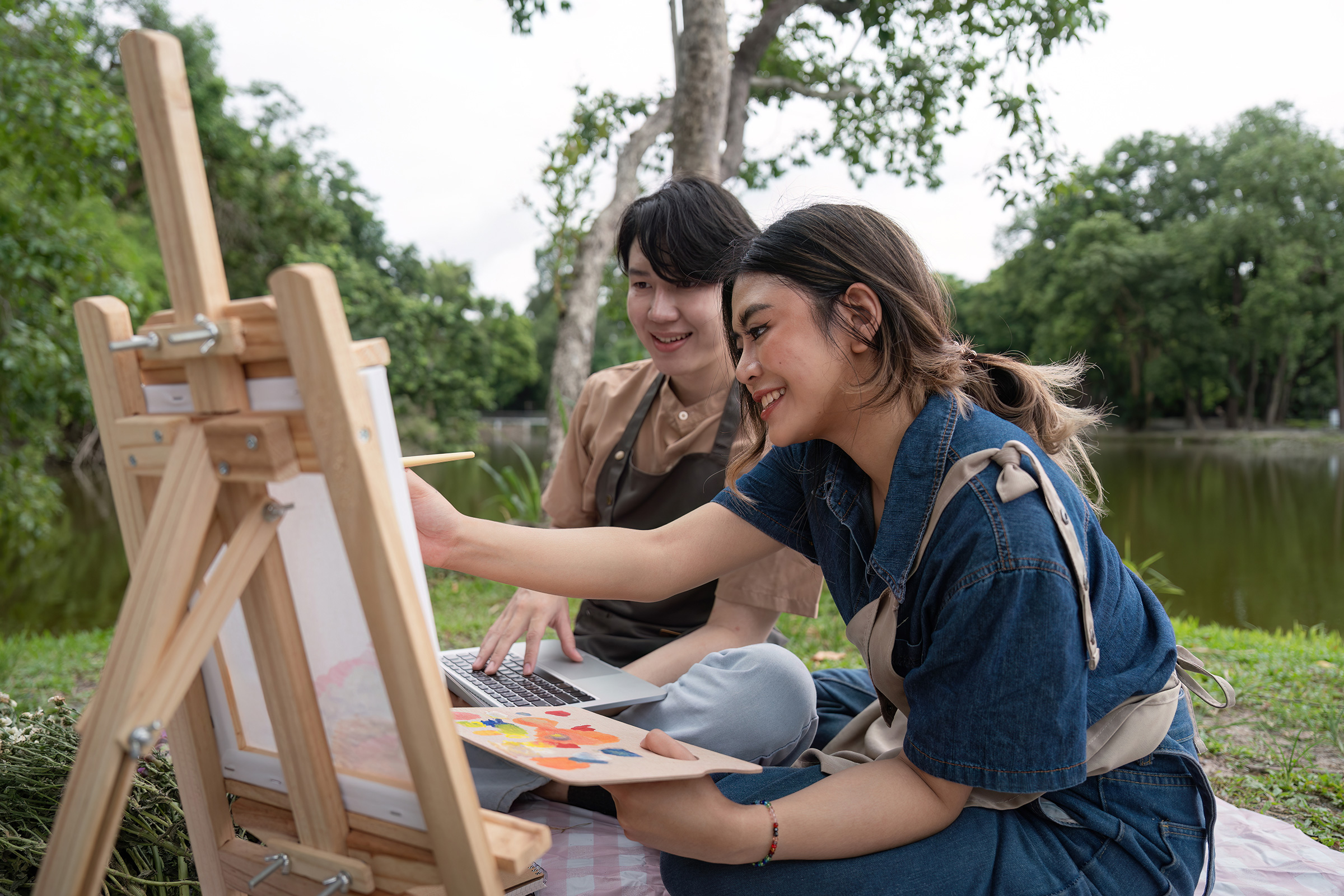 romantic couple enjoys a picnic while painting