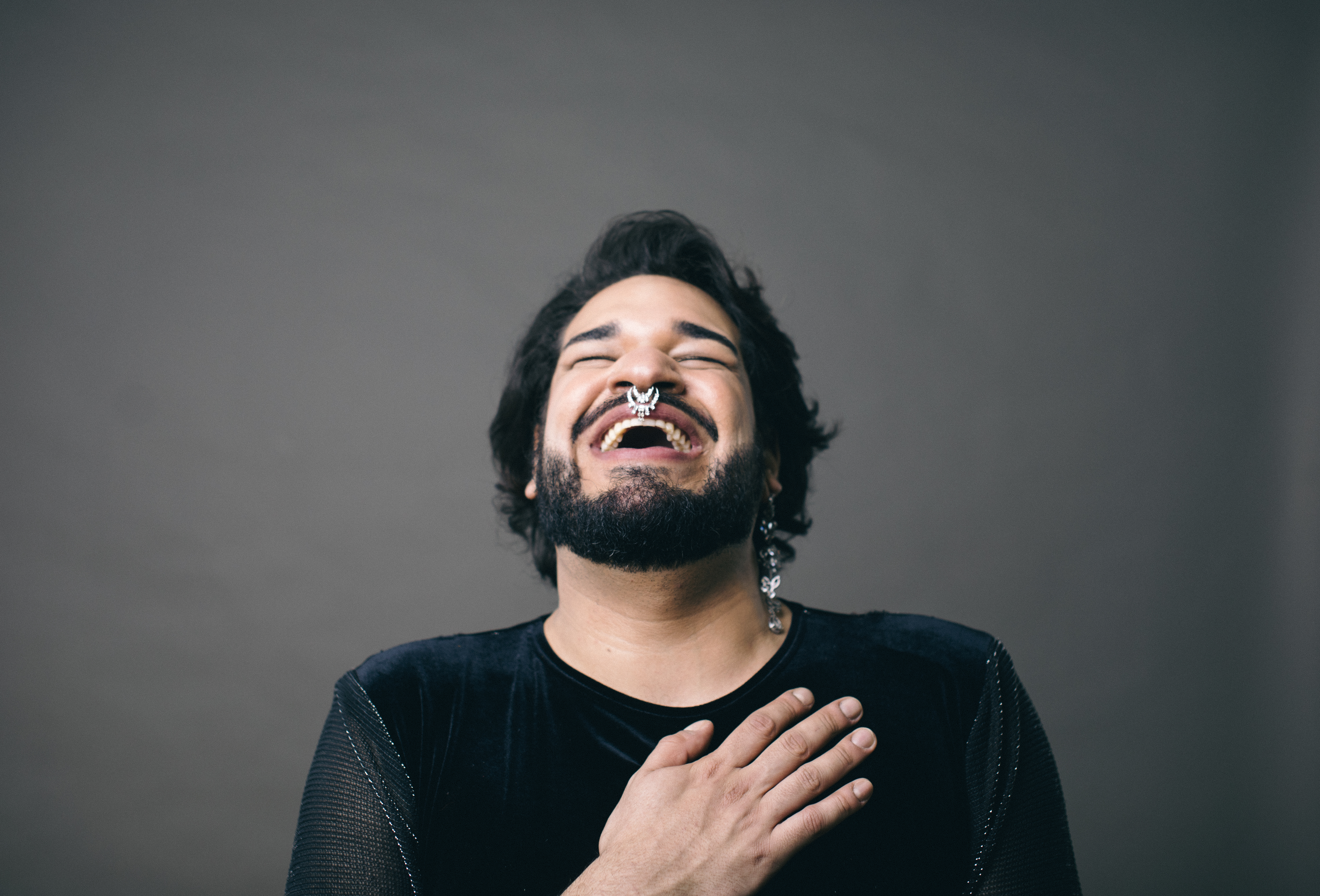 Handsome Irish redhead man with beard wearing glasses over pink isolated background smiling and laughing hard out loud because funny crazy joke with hands on body.