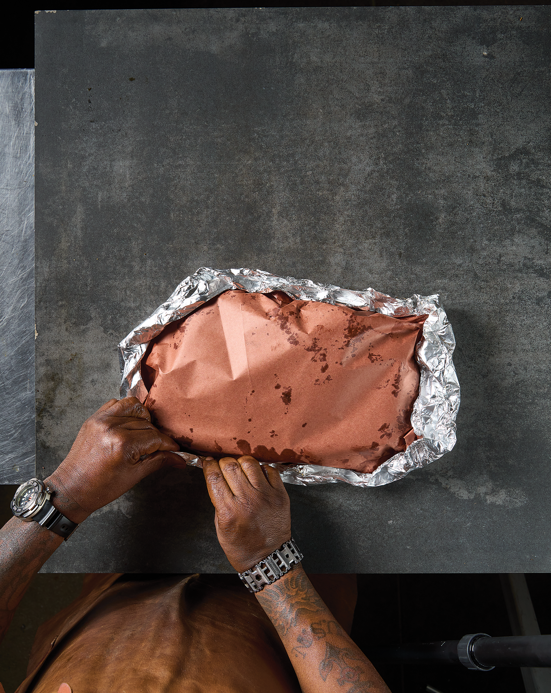 The brisket wrapped in paper and foil.