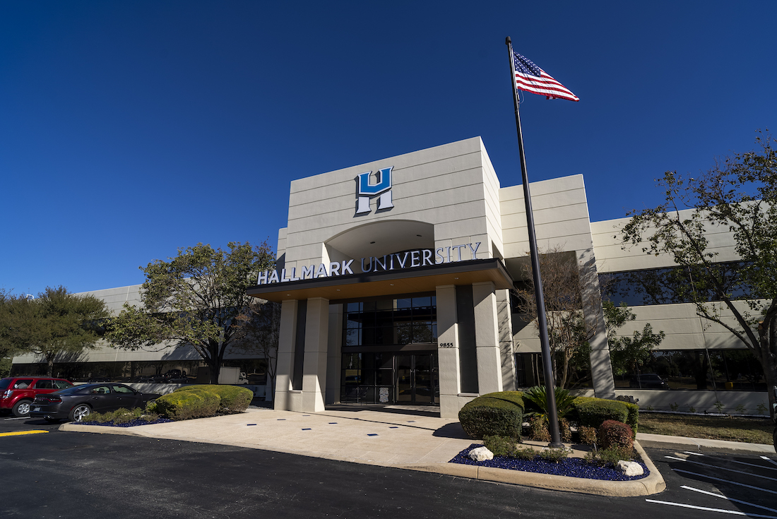 Female manager stands addressing team at board meeting