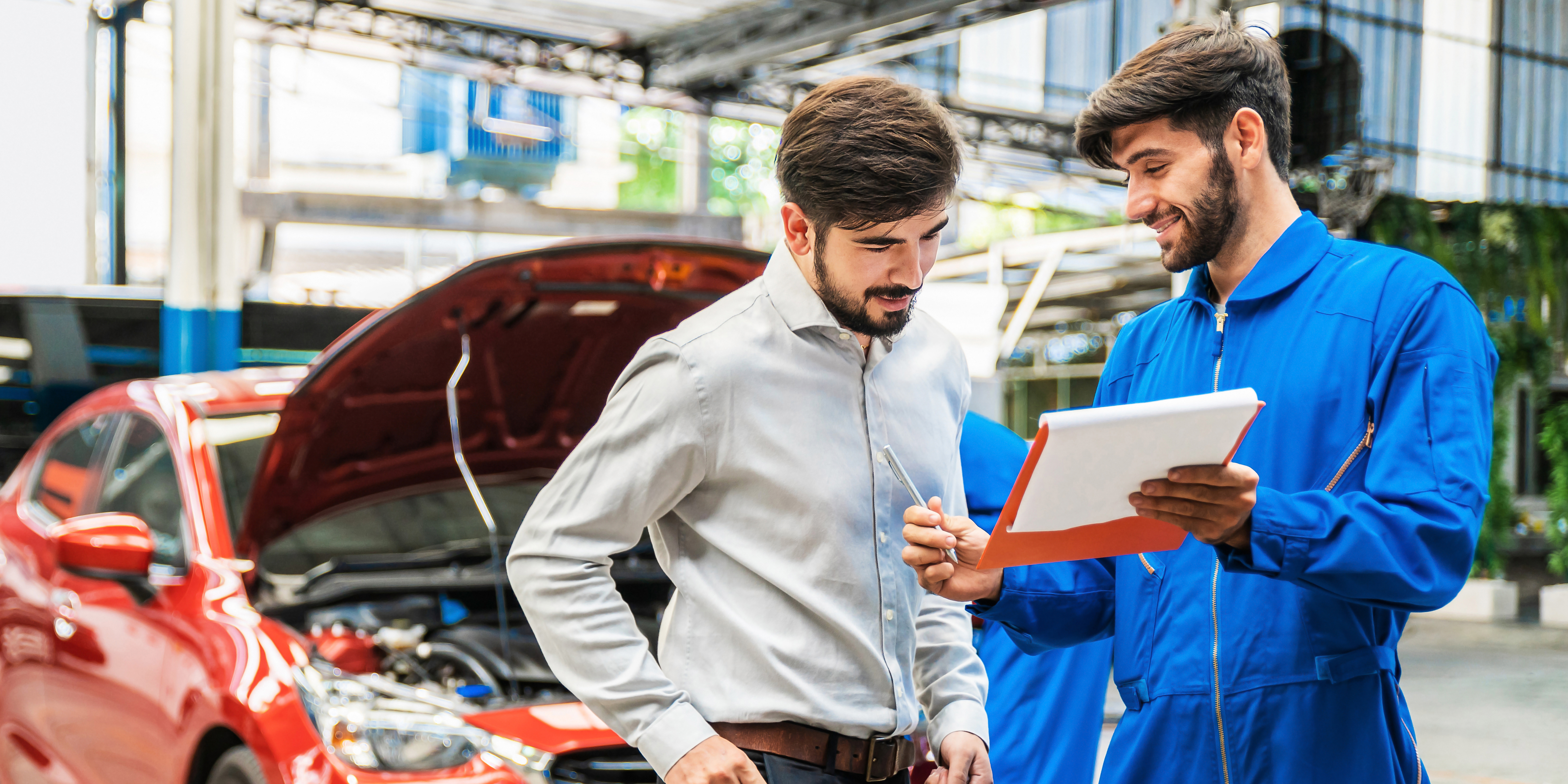 Mechanic and client talking about vehicle repairs and motor claims