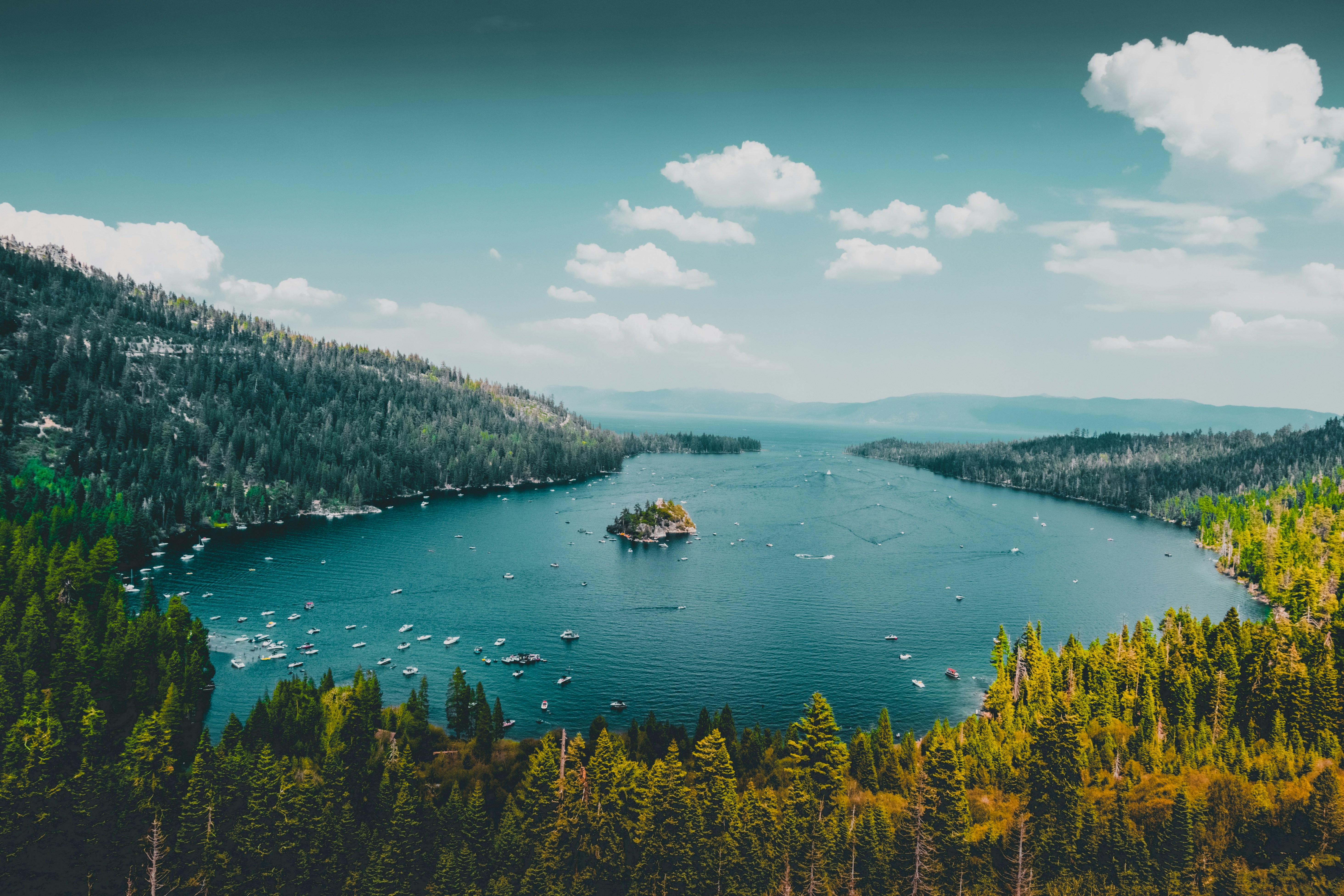 A serene lake nestled amidst towering trees and majestic mountains at Lake Tahoe.