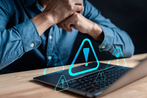 Caution icons overlaid on a business man