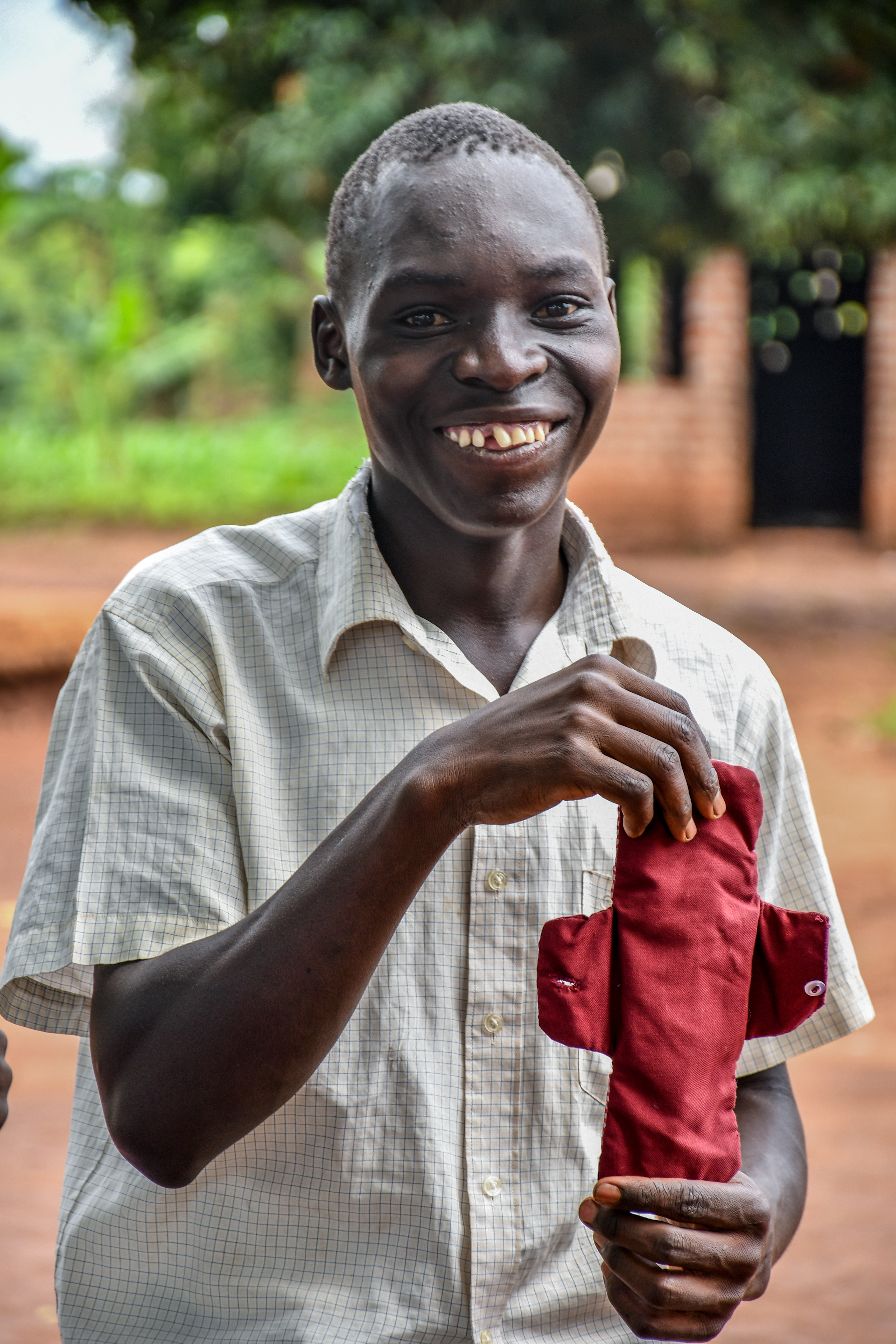 Jimmy, 16, with one of the reusable sanitary pads he made at the health club 