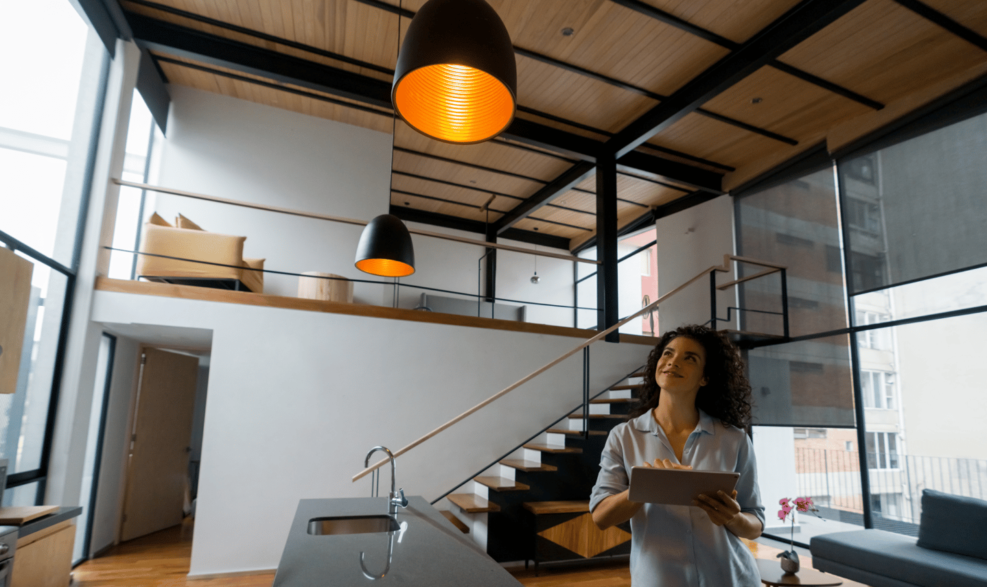 woman controlling the lights of her smart home with a tablet