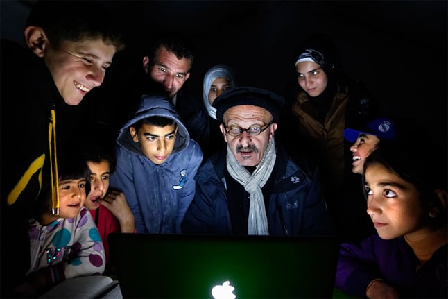 Reza teaching children