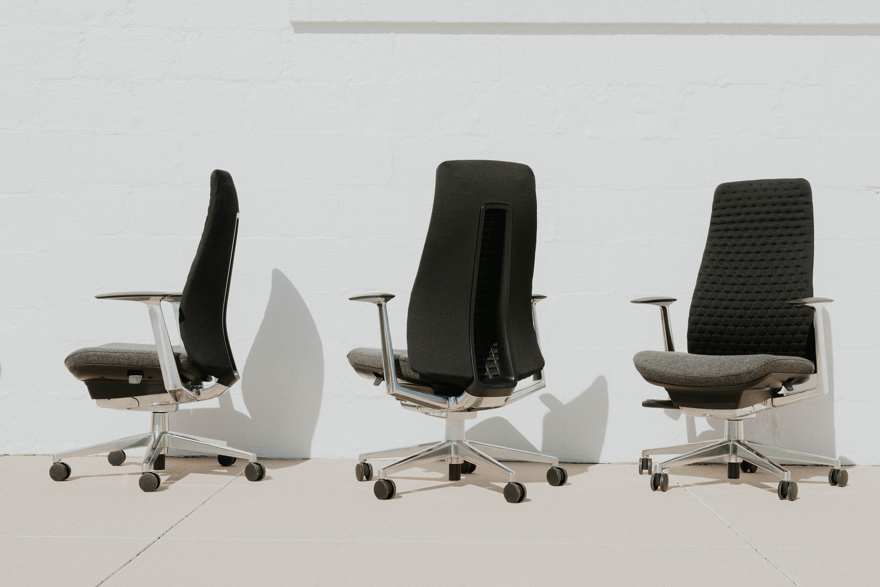 Attractive aged businesswoman, teacher or mentor coach speaking to young people, senior woman in glasses teaching audience at training seminar, female business leader speaker talking at meeting