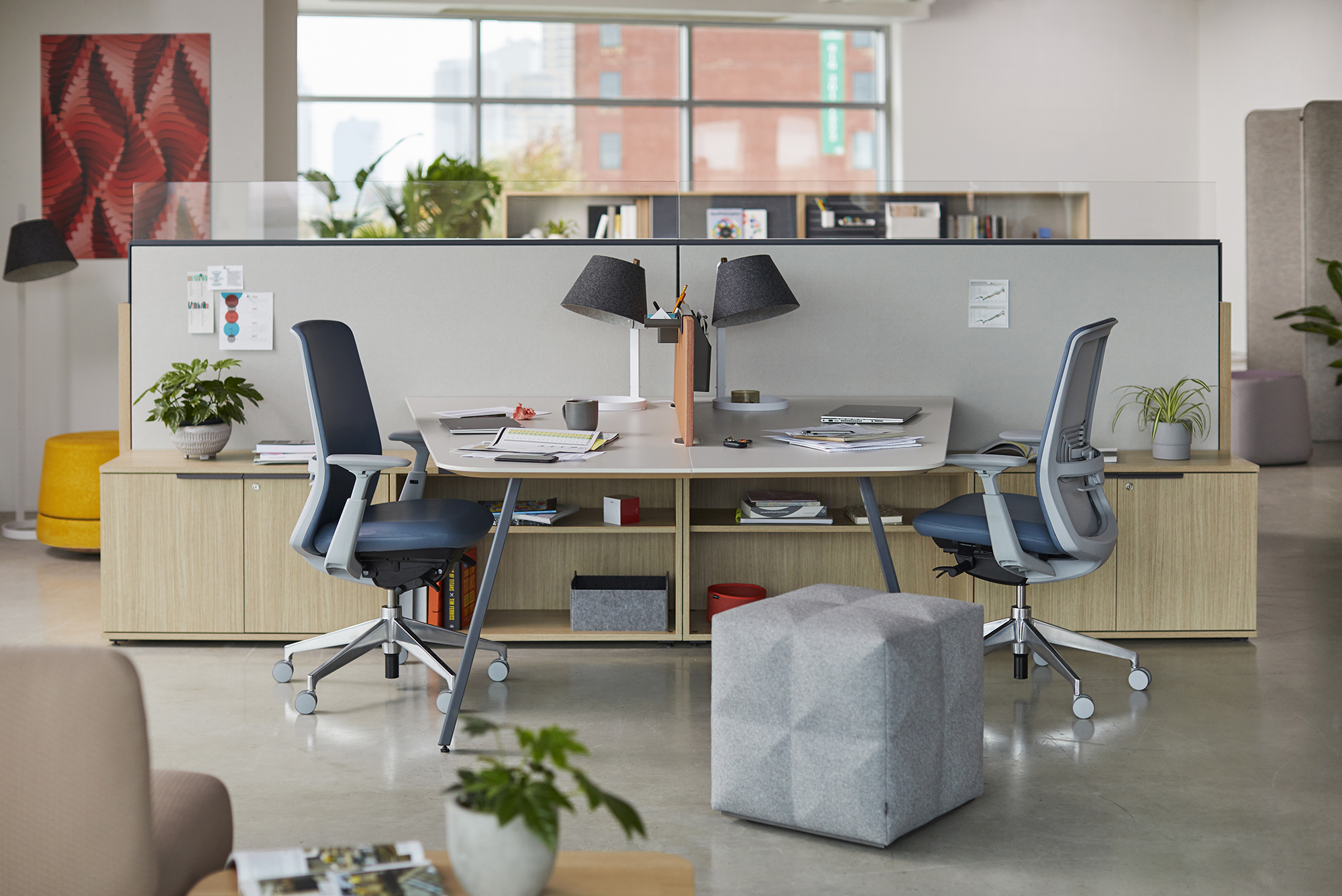 Female manager stands addressing team at board meeting